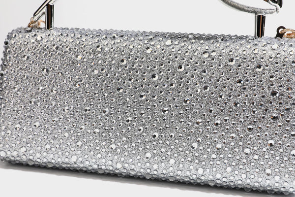 rectangular hard-case rhinestone evening clutch with sculptural gold-tone branch-and-bud top handle and detachable chain