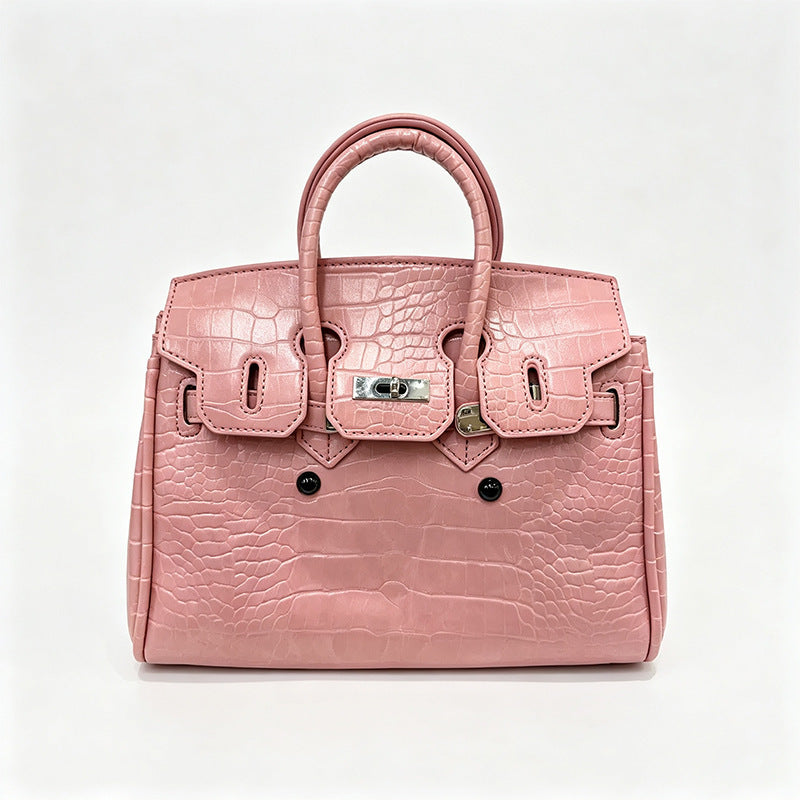 Croc-embossed structured trapezoid satchel with silver turn-lock hardware, rounded top handles, and detachable shoulder
