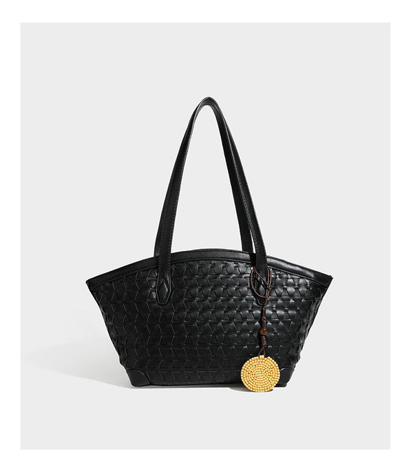 Large leather-look tote bag with geometric woven emboss, double shoulder straps, and round woven cord charm in brown, detail