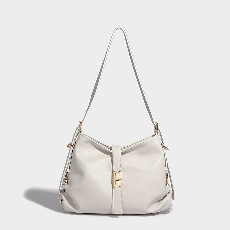 Soft slouchy hobo shoulder bag with smooth leather-look finish, gold-tone buckle and tab hardware, and long adjustable strap