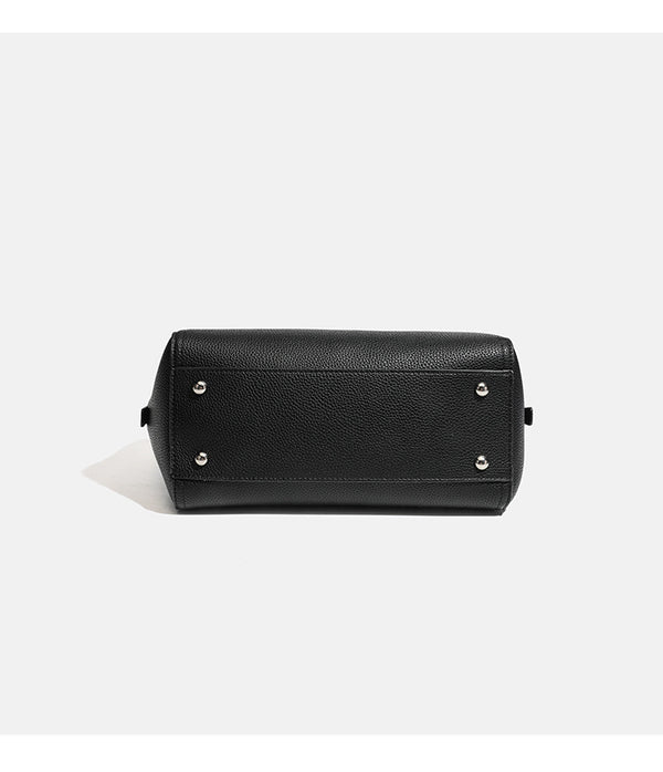 Structured pebbled leather-look top-zip barrel bag with dual handles, detachable shoulder strap, and attached croc-pattern