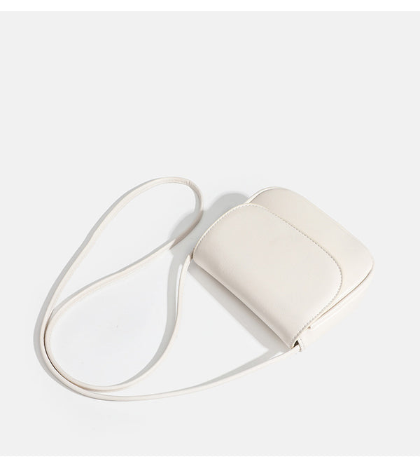 Compact rounded rectangular flap crossbody bag with glossy leather-look finish and long shoulder strap, detail view 18