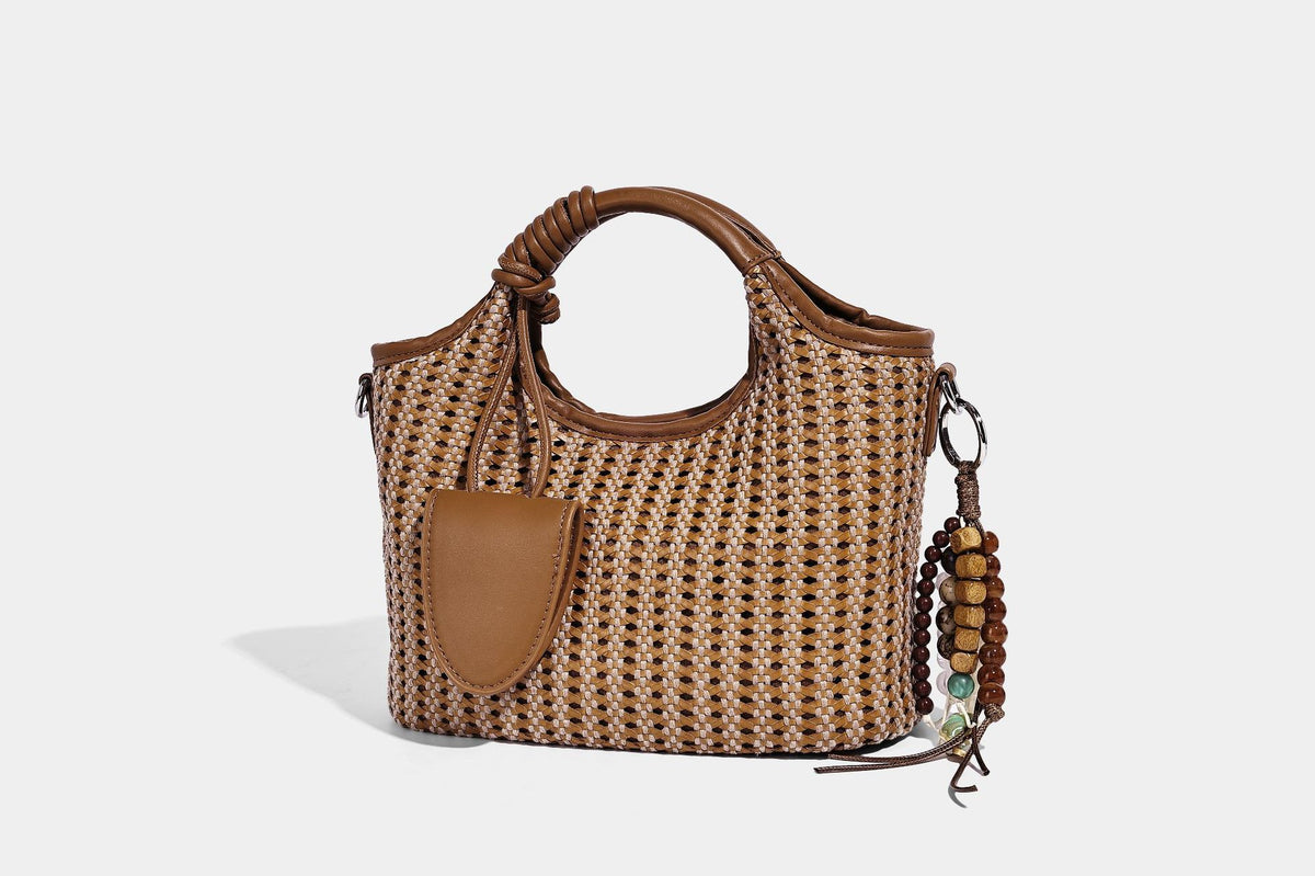 Small structured woven tote crossbody bag with ring top handle, leather-look brown trim, front patch pocket, and detachable