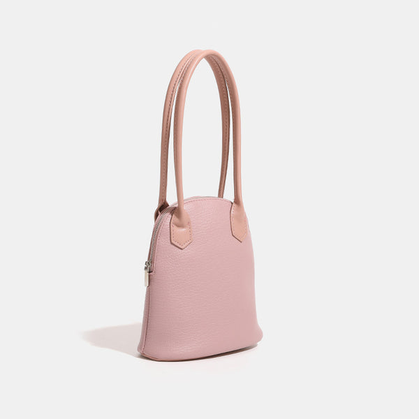 Rounded shell handbag with pebbled leather-look finish, dual top handles, and silver-tone zipper, detail view 3