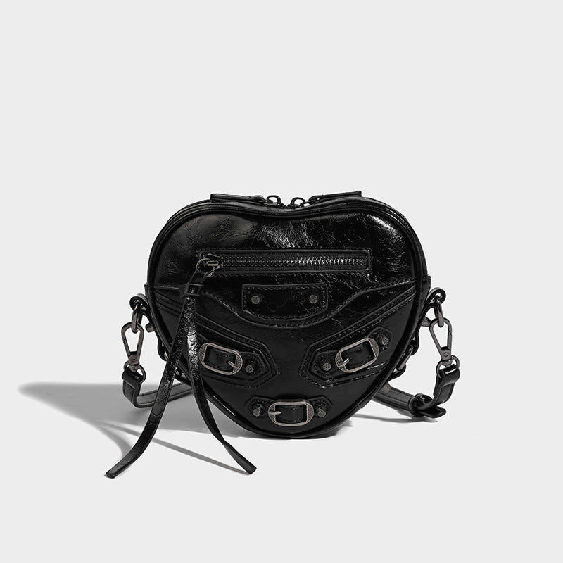 Mini heart-shaped crossbody bag with glossy crinkled finish and moto buckle hardware, detail view 18