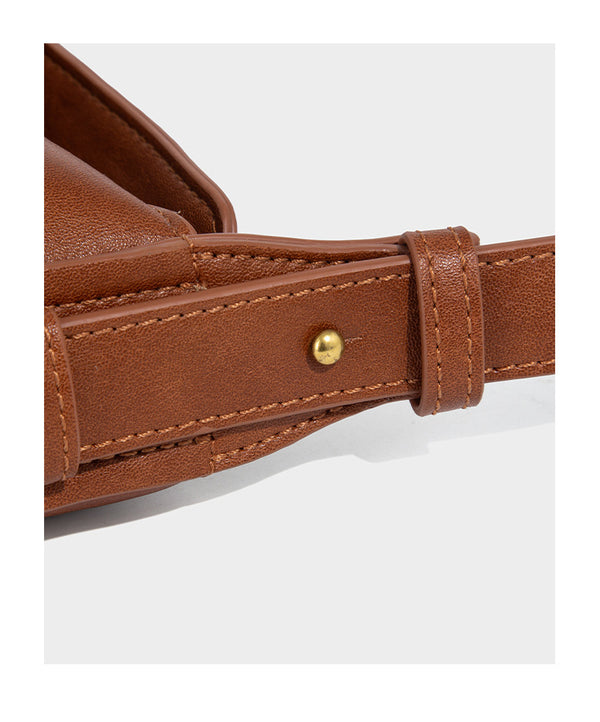 Slouchy brown leather-look shoulder bag with knotted drawcord tie closure, gold-tone ring hardware, and long adjustable