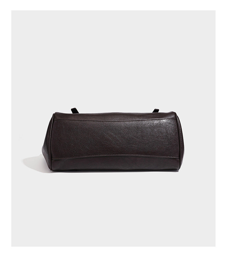 Large structured vintage-style tote bag with flap-front turn-lock closure, twin buckle straps, and double shoulder handles