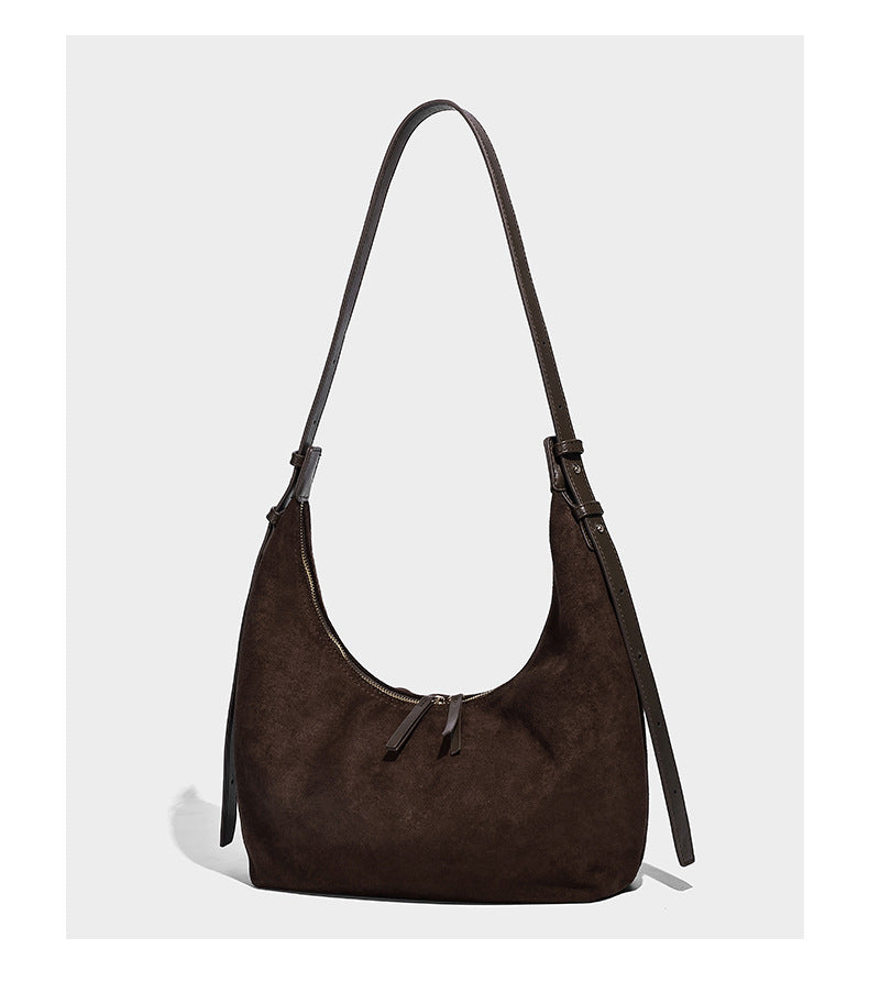 Slouchy crescent hobo shoulder bag in dark chocolate matte suede-look finish with adjustable strap and twin-pull top zip