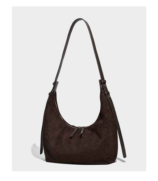 Slouchy crescent hobo shoulder bag in dark chocolate matte suede-look finish with adjustable strap and twin-pull top zip