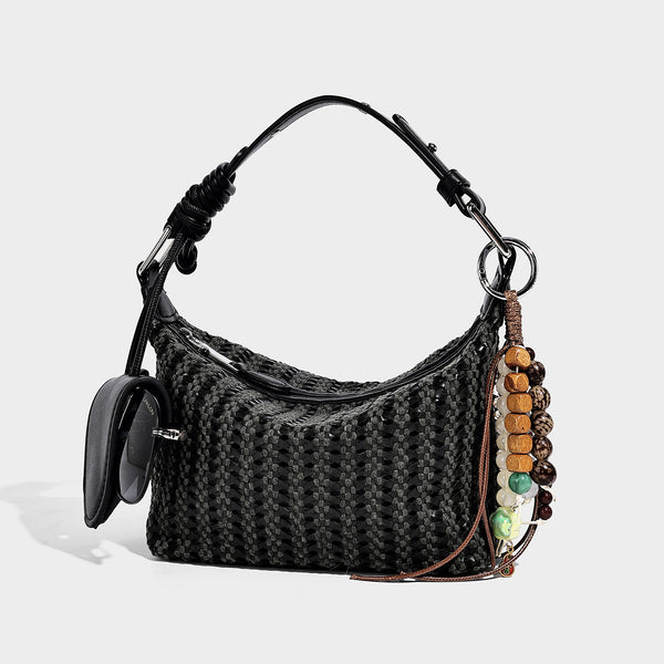 Woven crescent shoulder bag with leather-look knotted handle, zip top, attached mini pouch, and silver-tone hardware, detail