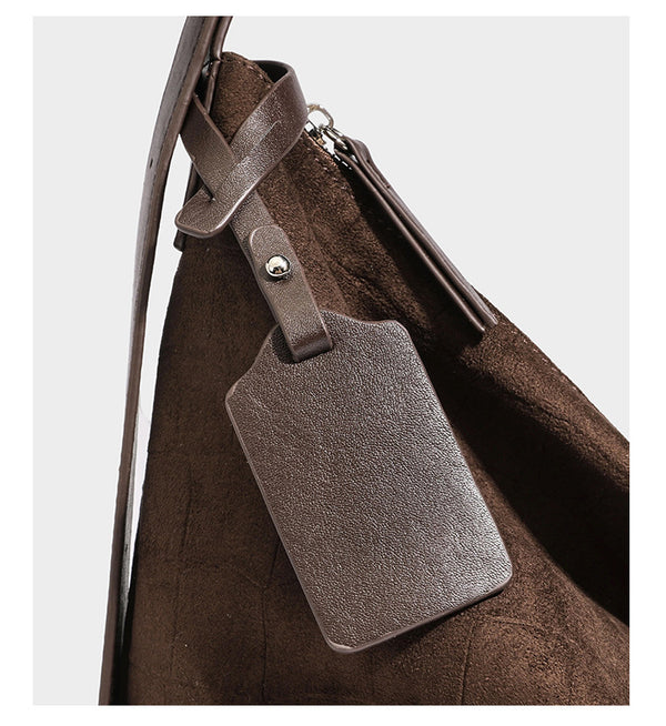 Slouchy hobo shoulder bag in matte croc-embossed leather-look finish with top zip closure and long adjustable strap, detail