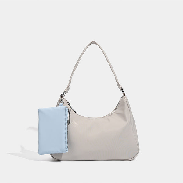 Curved hobo shoulder bag with detachable zip pouch in matte-satin finish with silver-tone hardware, front view