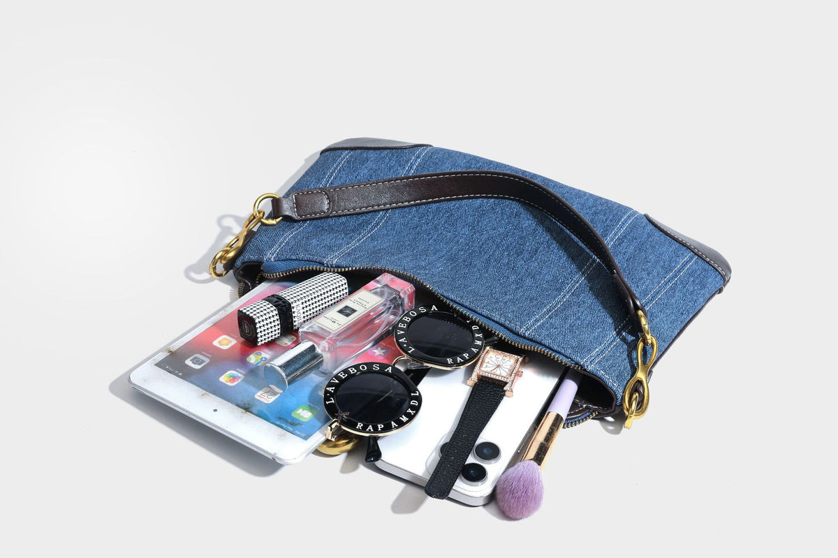 Slouchy denim shoulder bag with dark leather-look trim, gold-tone chain-link hardware, and top zipper closure, detail view 37