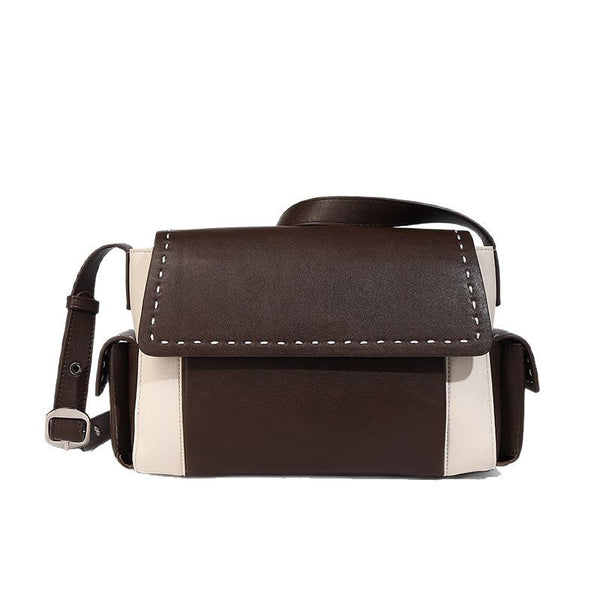 Structured flap crossbody bag in dark brown and cream color-block with white contrast stitching, adjustable shoulder strap