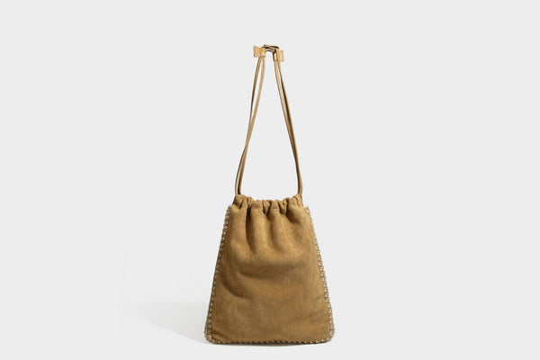 Matte suede-look drawstring bucket bag with cream braided woven edge trim and slim adjustable leather-look shoulder strap