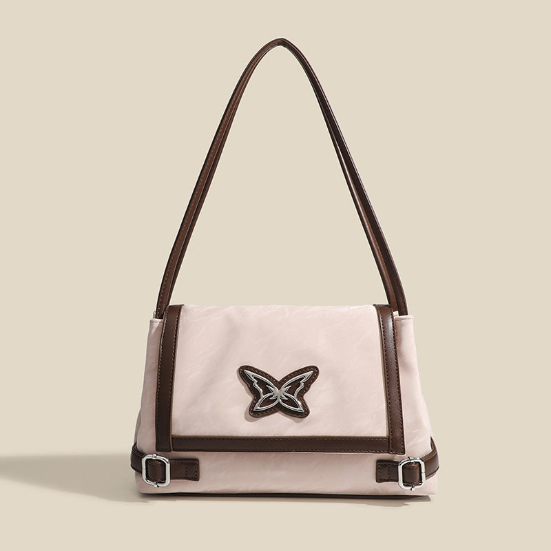 Structured crinkle-finish flap shoulder bag with butterfly metal appliqué and dark brown contrast trim, front view