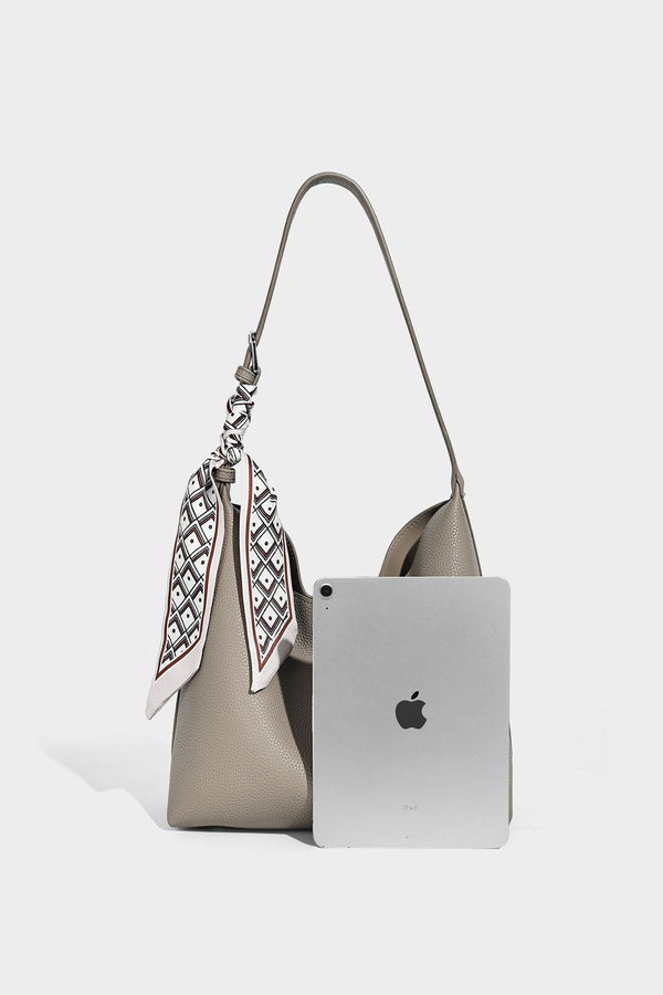 Soft slouchy hobo shoulder bag in pebbled matte finish with slim strap, silver-tone ring hardware, and knotted printed scarf