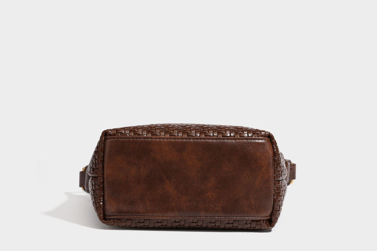 Small glossy basket-weave hobo shoulder bag in brown with knotted top handle, flap accent pocket, and gold-tone hardware