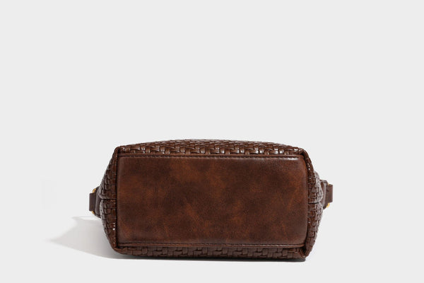Small glossy basket-weave hobo shoulder bag in brown with knotted top handle, flap accent pocket, and gold-tone hardware