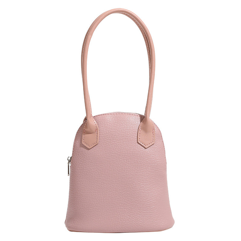 Rounded shell handbag with pebbled leather-look finish, dual top handles, and silver-tone zipper, detail view 5
