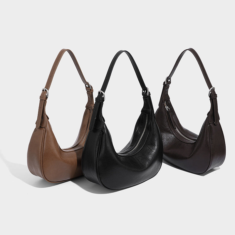 Crescent half-moon shoulder bag in pebbled leather-look finish with adjustable strap and silver-tone hardware, detail view 2