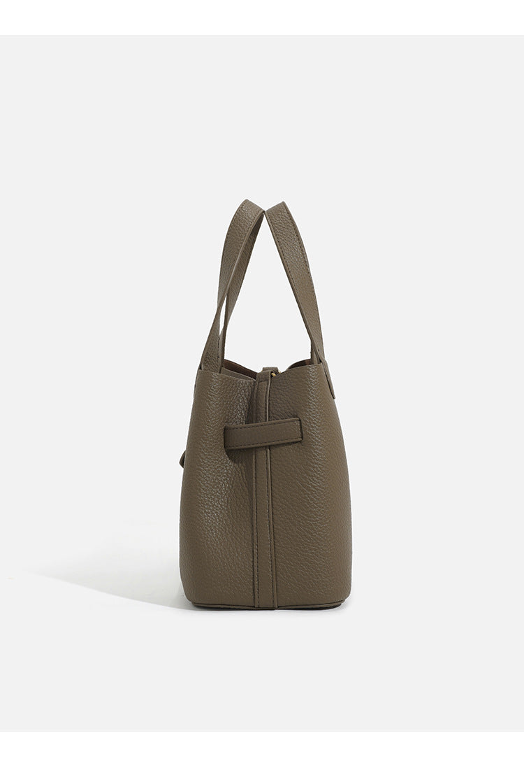 Pebbled trapezoid tote bag with gold turn-lock strap detail and matching snap pouch, detail view 10