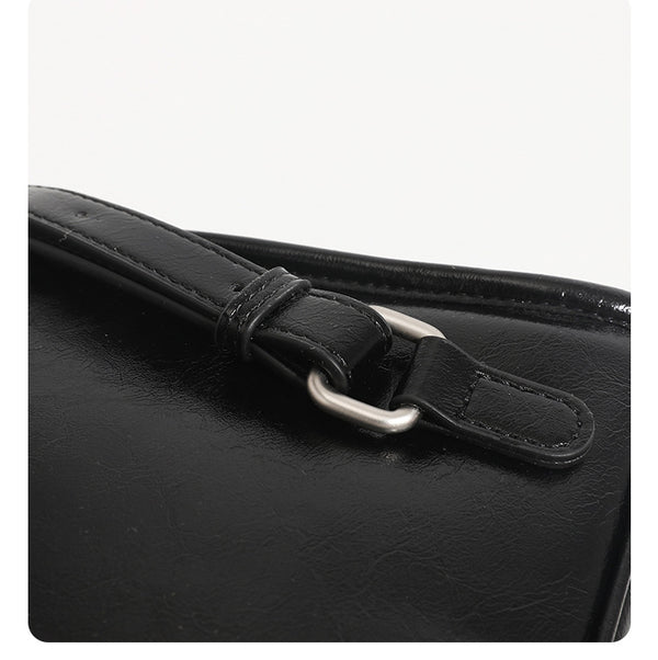 Structured glossy leather-look flap backpack handbag with dual buckle closures, top handle, and silver-tone hardware, detail