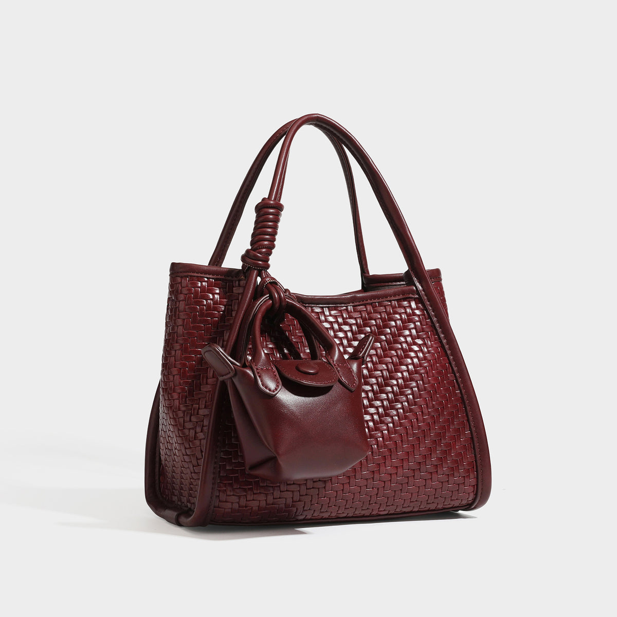 Strukturierte Tote Bag mit Webstruktur in Braun, glatten Besätzen in Lederoptik, geknoteten Tragegriffen und befestigtem Mini-Beutel mit Kordelzug