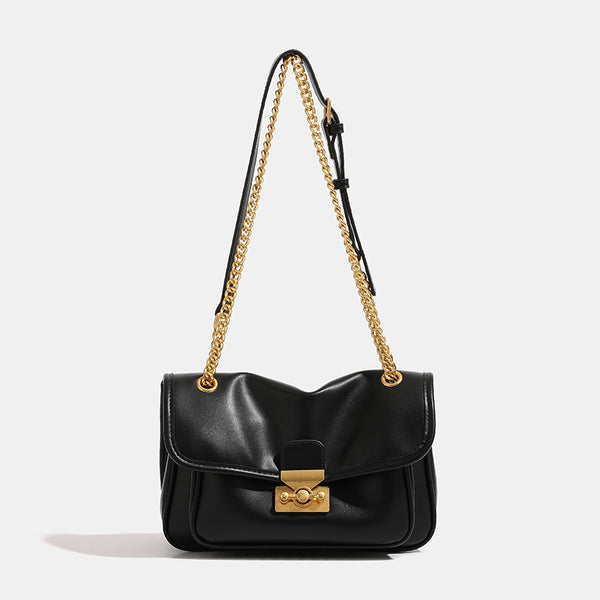 Smooth leather-look flap crossbody bag with chunky gold-tone chain strap and double-knob twist lock, detail view 6