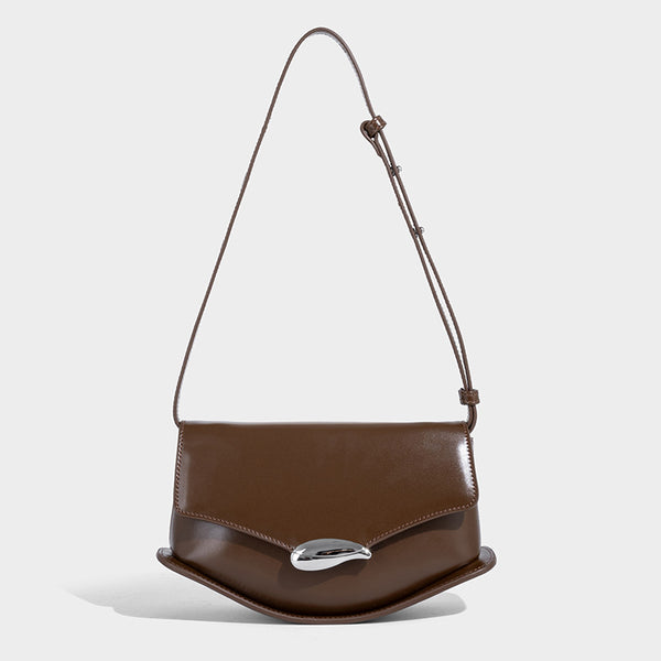 Small structured saddle bag with glossy leather-look finish, angular flap front, silver-tone metal clasp, and slim