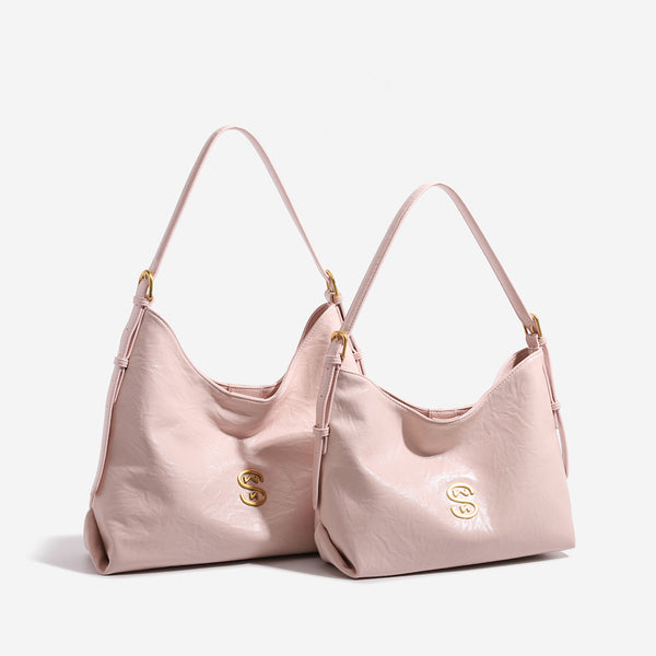 Crinkled leather-look hobo shoulder bag with gold-tone logo emblem and slim adjustable strap, front view