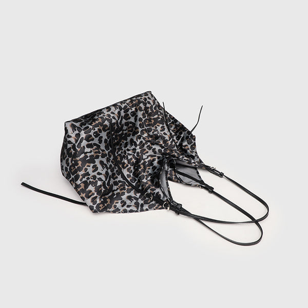 Large leopard-print slouchy tote shoulder bag in grey, black, and tan with gold-tone hardware and adjustable leather-look