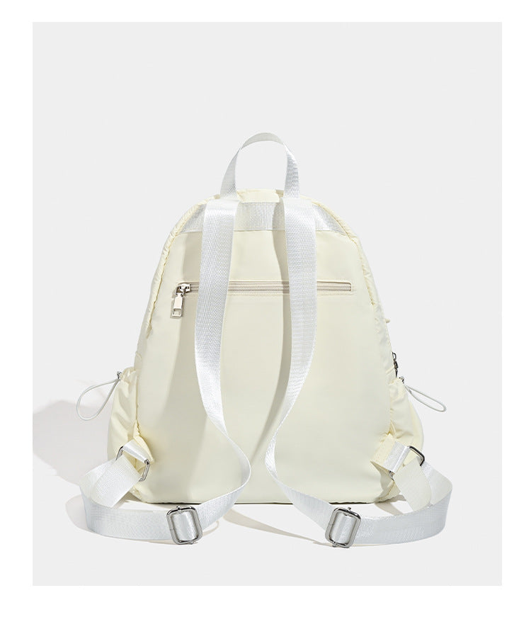 Puffy matte nylon mini backpack with drawcord gathered front pockets and silver-tone hardware, detail view 10