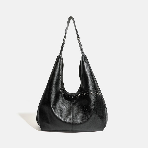 Large slouchy hobo shoulder bag with silver eyelet trim and glossy leather-look finish, detail view 6