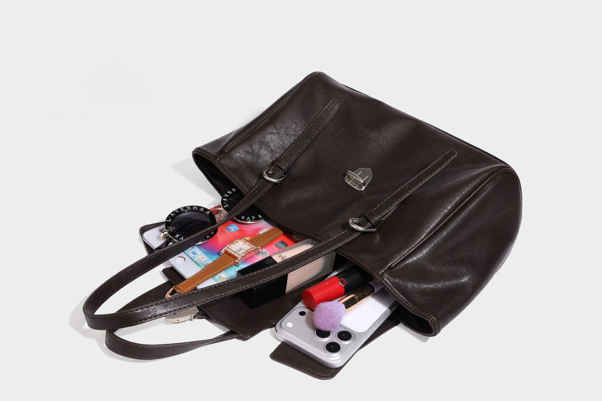 Large structured vintage-style tote bag with flap-front turn-lock closure, twin buckle straps, and double shoulder handles