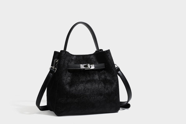 Small structured bucket satchel in embossed velvet-texture fabric with silver turn-lock hardware, rounded top handle, and