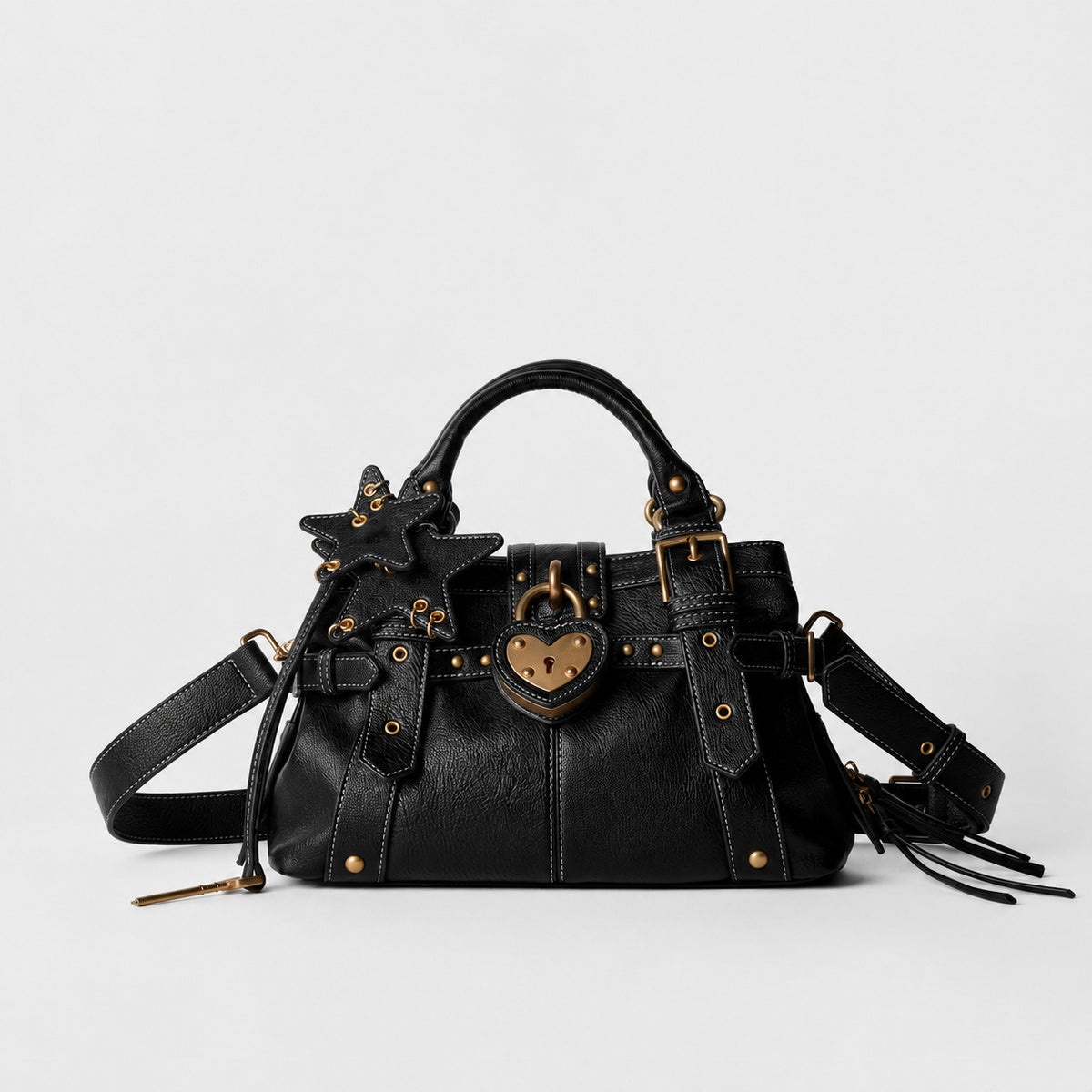 Structured satchel bag with heart-shaped padlock hardware, rivet studs, star charm, and twin top handles, detail view 6