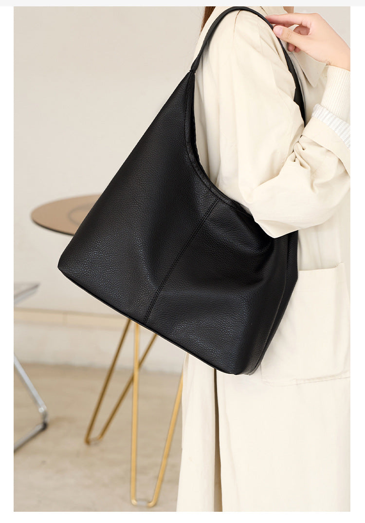 Large slouchy hobo shoulder bag in pebbled matte leather-look finish with single flat strap, detail view 8
