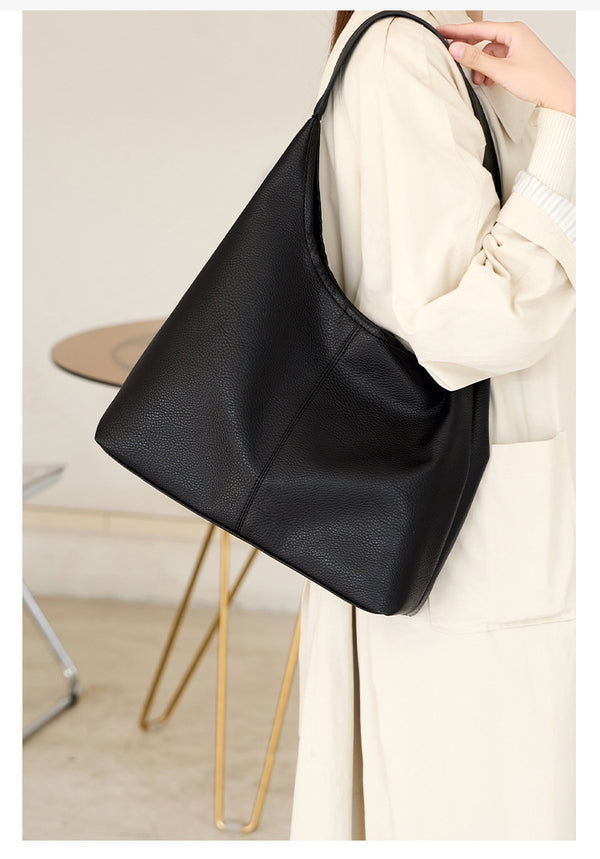 Large slouchy hobo shoulder bag in pebbled matte leather-look finish with single flat strap, detail view 8