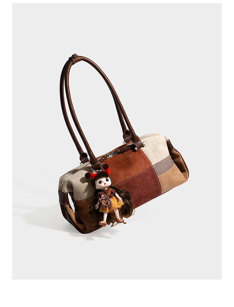 Patchwork suede-look barrel shoulder bag in brown, rust, tan, beige, and gray panels with double leather-look straps and