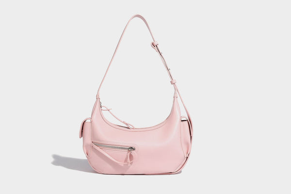 Smooth leather-look crescent shoulder bag with front zip pocket, side flap pockets, adjustable strap, and silver-tone, detail