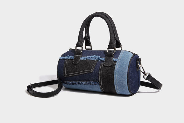 Mini barrel handbag in light and dark denim patchwork with frayed seam trim, dual top handles, top zip closure, and, detail