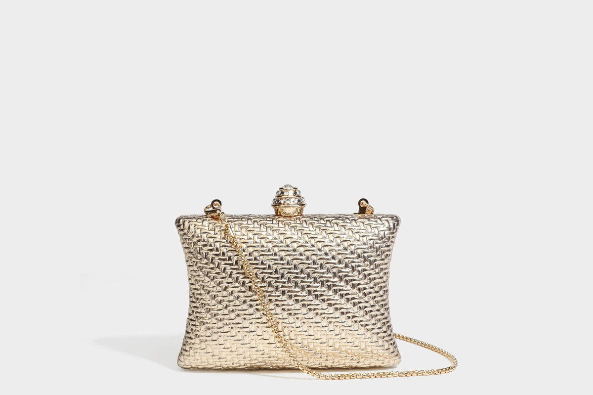 Small structured rectangular metallic woven-texture clutch bag with jeweled knob clasp and gold-tone chain strap, detail view