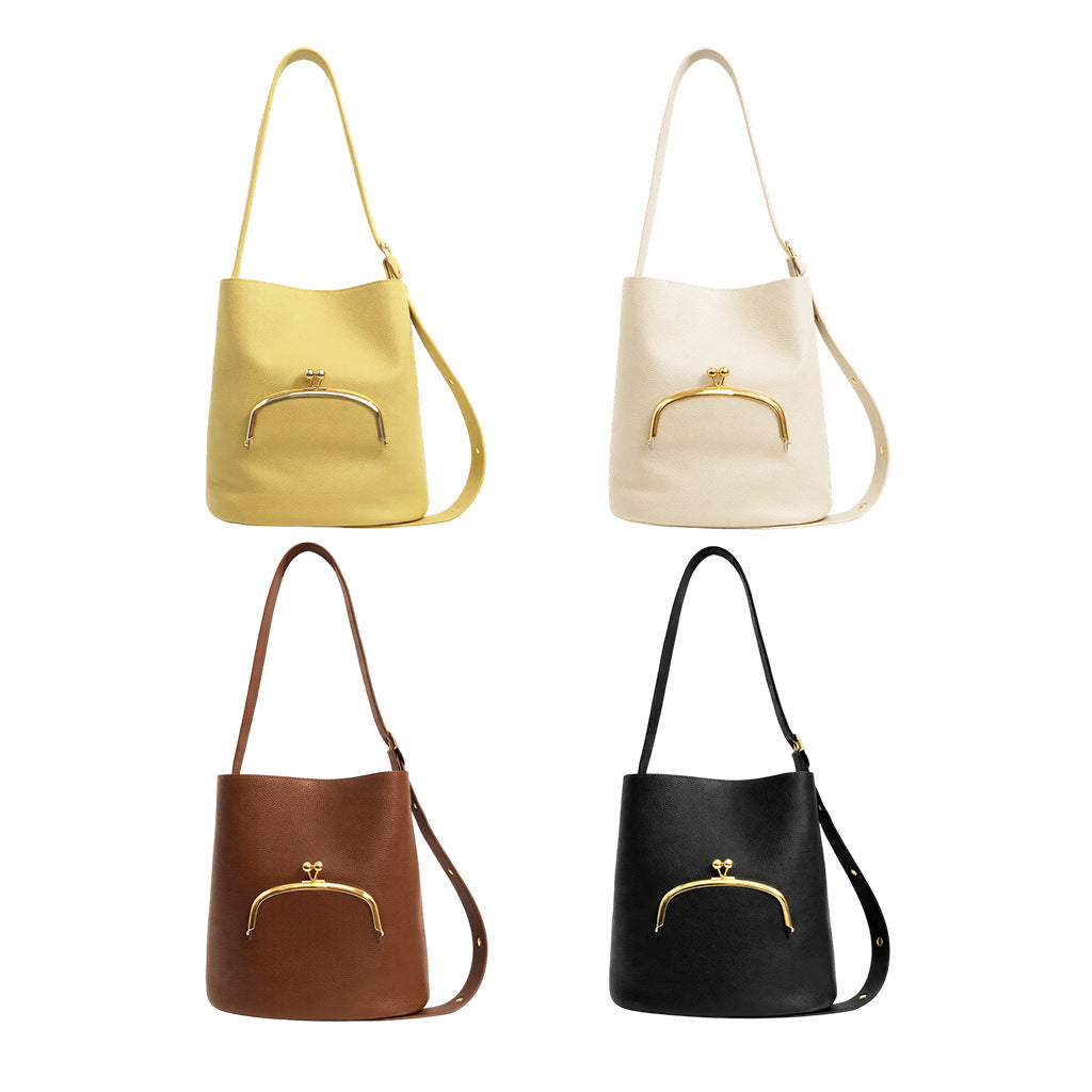 Pebbled textured bucket bag with gold-tone kiss-lock front pocket and adjustable single shoulder strap, detail view 4