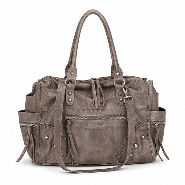 Large distressed leather-look moto tote bag with silver rivets, tassel zip pulls, front zip pocket, and dual top handles