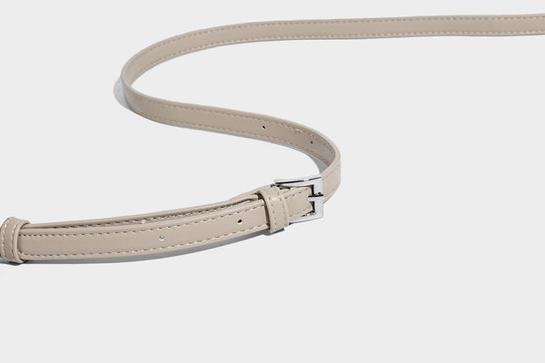 Small pebbled half-moon shoulder bag with dual top handles, detachable crossbody strap, and silver-tone hardware, detail view