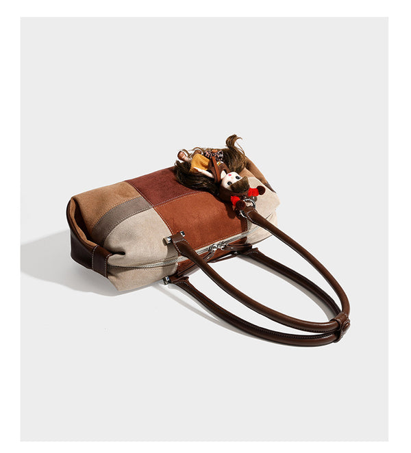 Patchwork suede-look barrel shoulder bag in brown, rust, tan, beige, and gray panels with double leather-look straps and