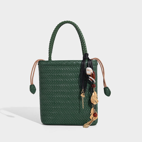 Small structured woven-texture tote bag with braided top handles and drawstring inner pouch, detail view 10