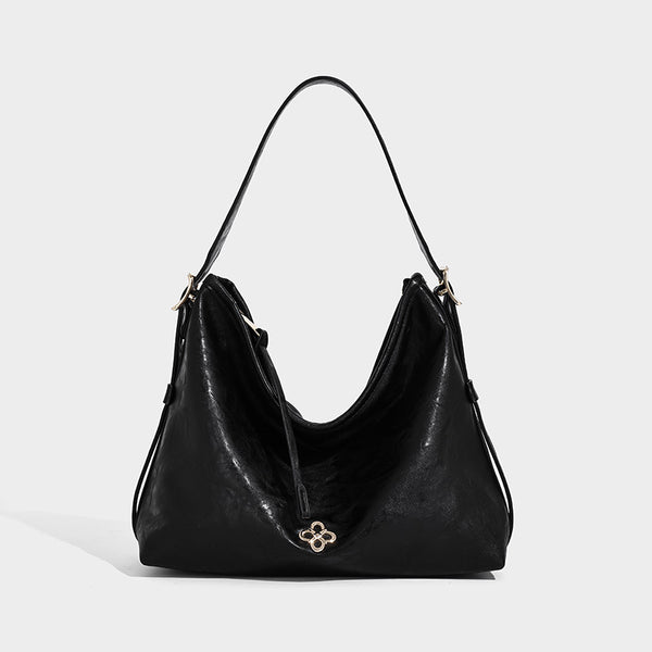 Slouchy leather-look hobo shoulder bag with gold-tone hardware and adjustable strap in brown, detail view 8