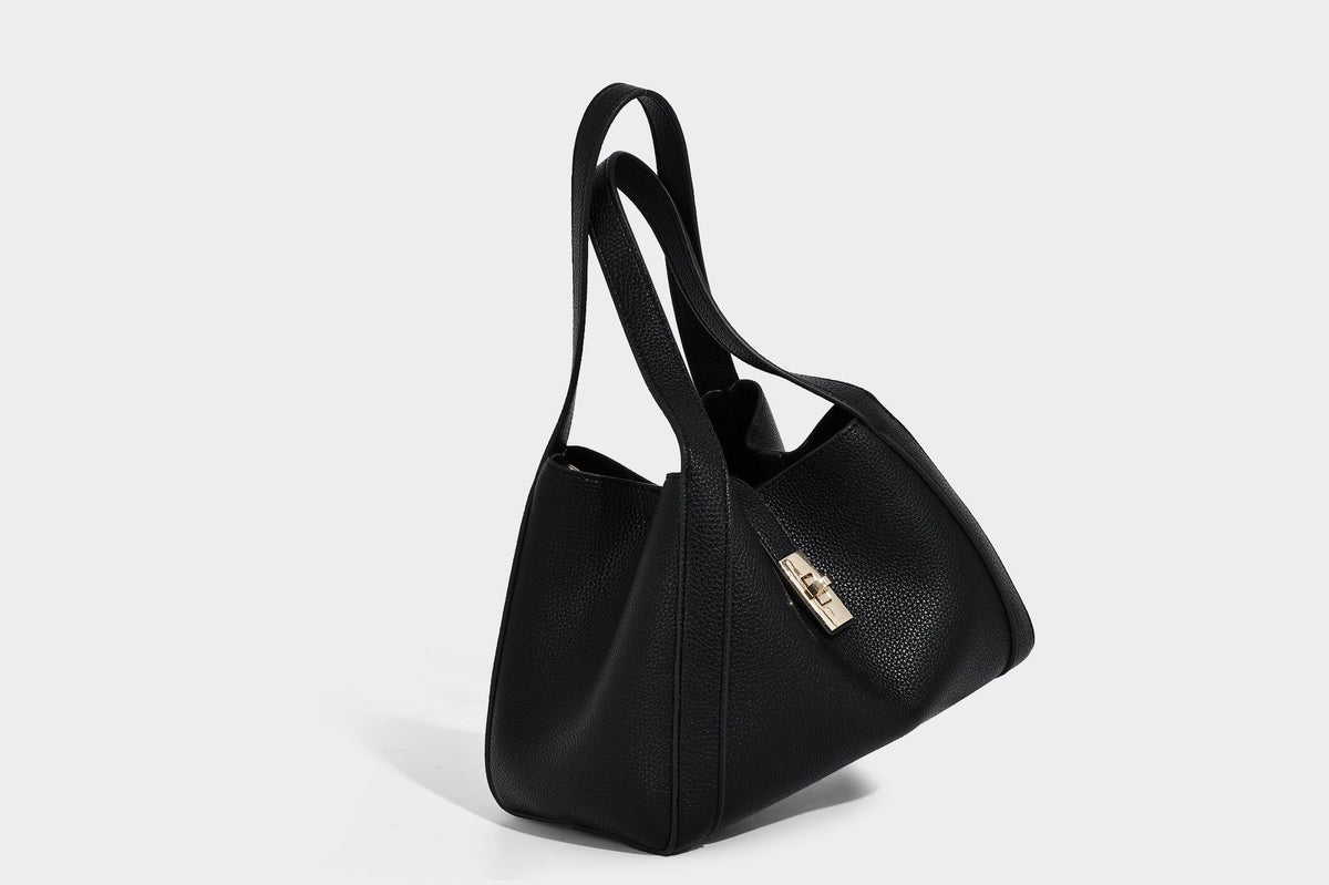 Structured trapezoid tote bag in taupe pebbled leather-look finish with gold-tone turn-lock hardware, dual top handles, and